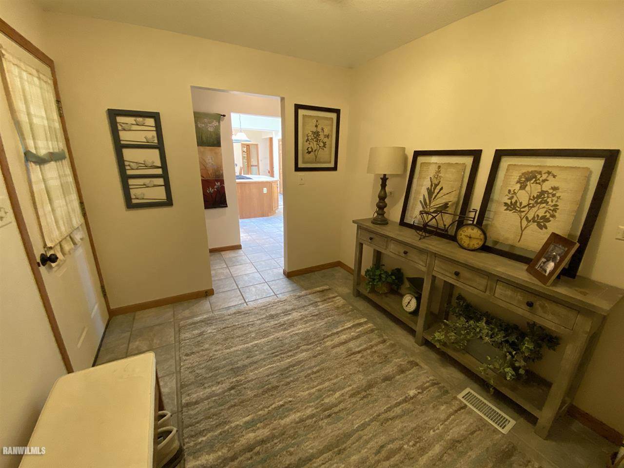 32180 Chambers Grove Road Lanark, IL 61046 - Photo 15 of 44 a view of a hallway with wooden floor and furniture