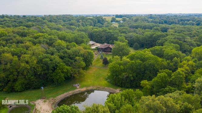 32180 Chambers Grove Road Lanark, IL 61046 - Photo 2 of 44 a view of a lake with a forest