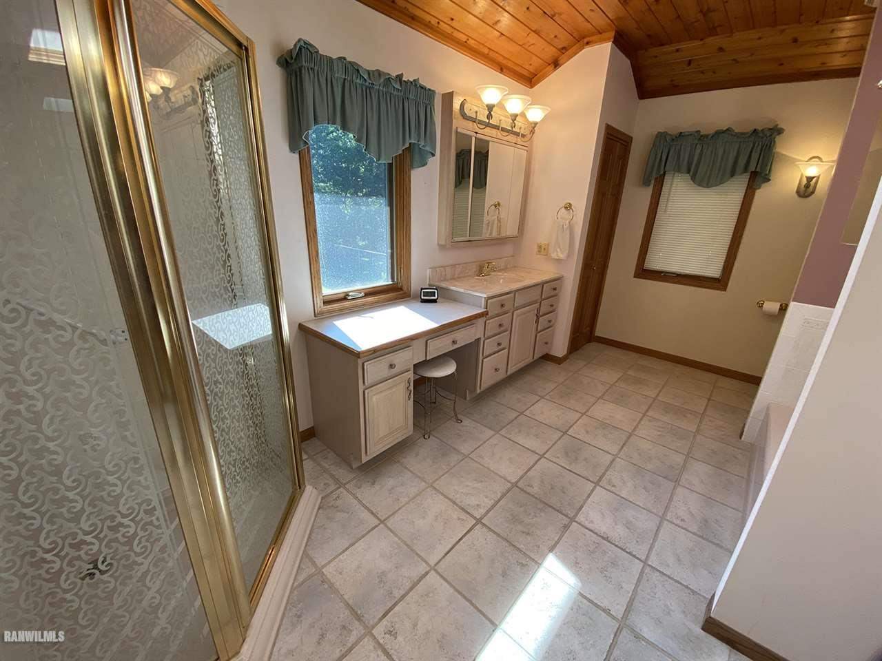 32180 Chambers Grove Road Lanark, IL 61046 - Photo 28 of 44 a bathroom with a sink a mirror and a shower
