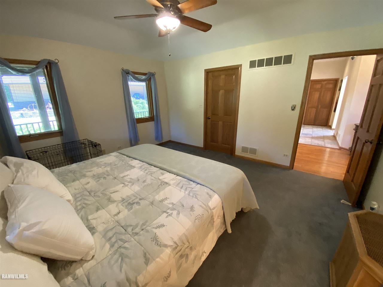 32180 Chambers Grove Road Lanark, IL 61046 - Photo 31 of 44 a bedroom with a bed and a mirror