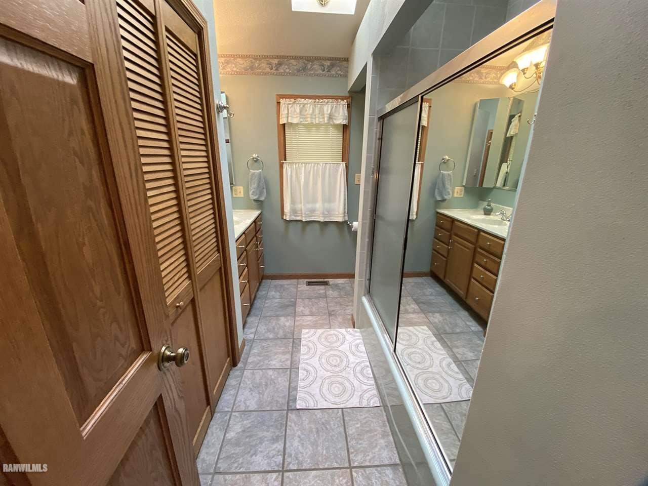 32180 Chambers Grove Road Lanark, IL 61046 - Photo 32 of 44 a bathroom with a sink and a mirror