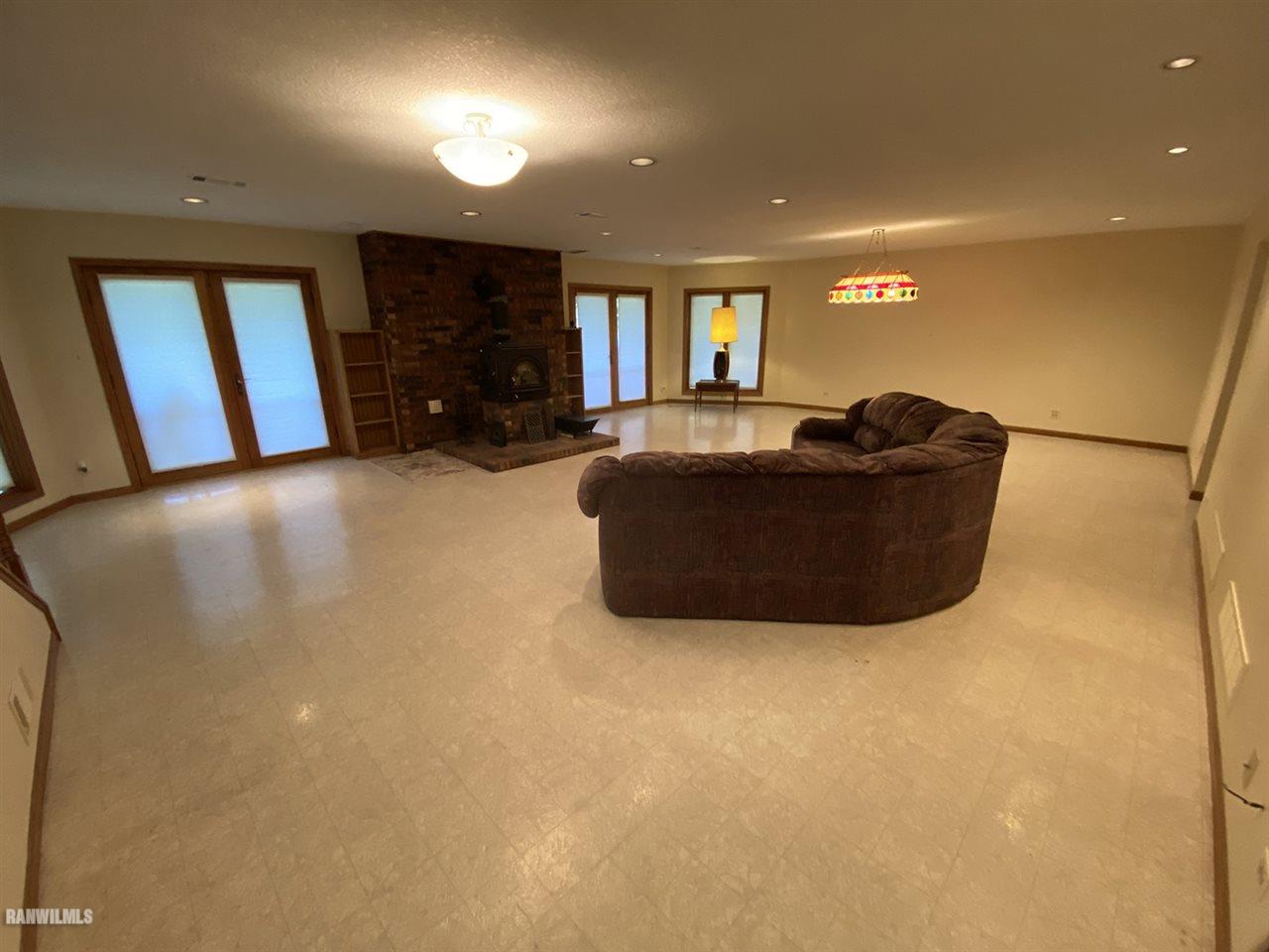 32180 Chambers Grove Road Lanark, IL 61046 - Photo 36 of 44 a living room with furniture and a flat screen tv