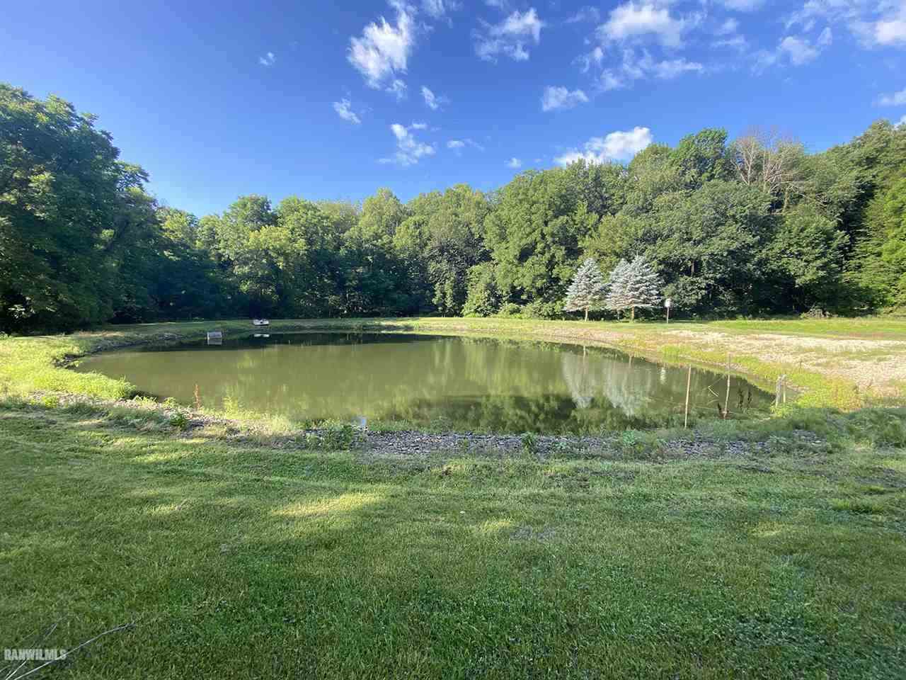 32180 Chambers Grove Road Lanark, IL 61046 - Photo 9 of 44 a view of a lake with a yard