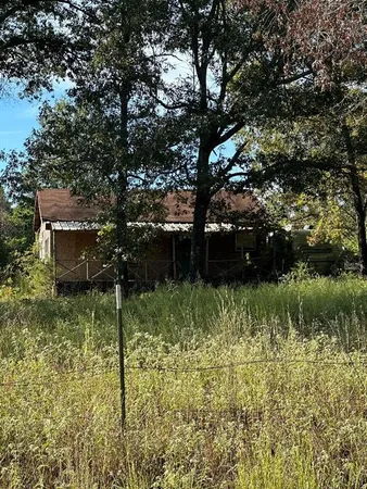 a backyard of a house with a yard and outdoor seating