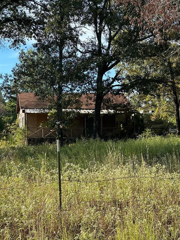 234 Private Road Powderly, TX 75473 - Photo 4 of 8 a backyard of a house with a yard and outdoor seating