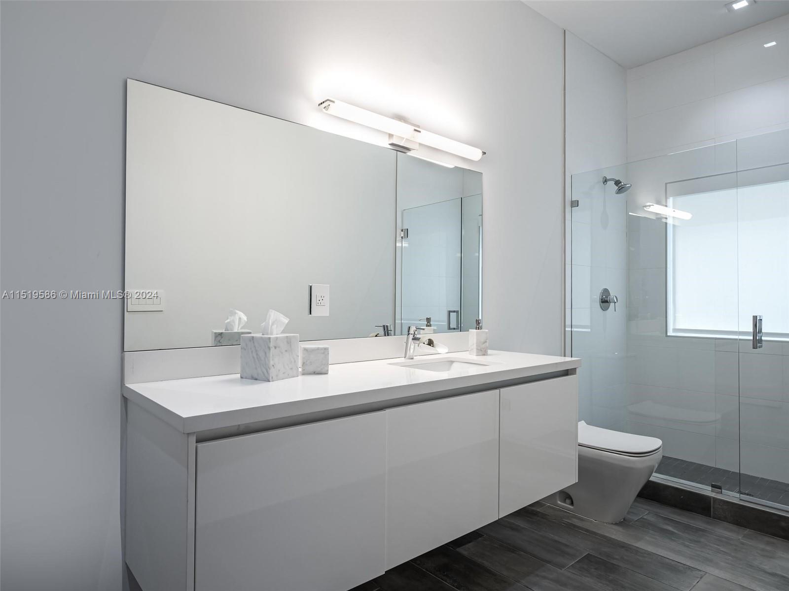 16601 Sunset Way Weston, FL 33326 - Photo 33 of 53 a bathroom with a toilet sink and mirror