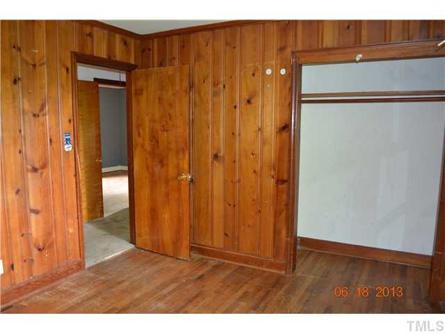 2719 Poole Road Raleigh, NC 27610 - Photo 6 of 8 an empty room with wooden floor