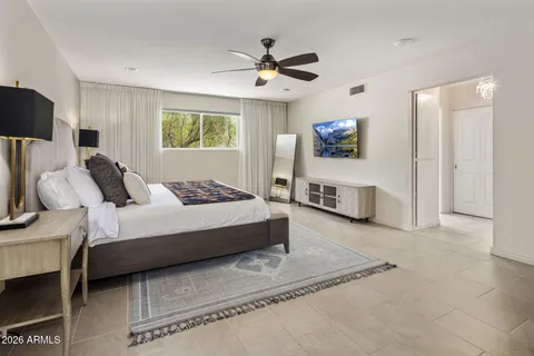a bedroom with a bed lamp and a dresser