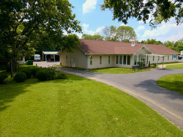 an aerial view of residential houses with outdoor space and trees