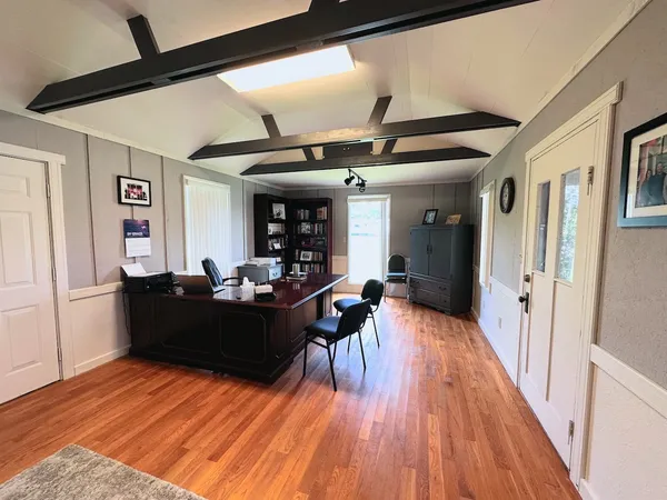 a large room with lots of furniture and wooden floor