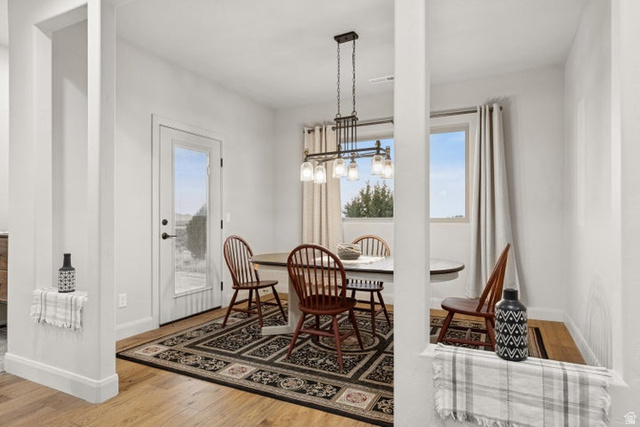 2925 Juniper Road Enterprise, UT 84725 - Photo 17 of 56 Dining space featuring light wood-style floors, healthy amount of natural light, and a chandelier