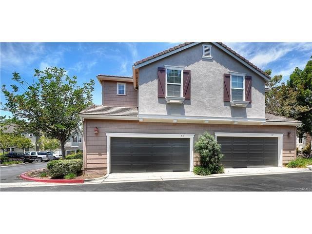 55 Ellsworth Street, Unit 27 Ladera Ranch, CA 92694 - Photo 29 of 34 a front view of a house with a yard and garage