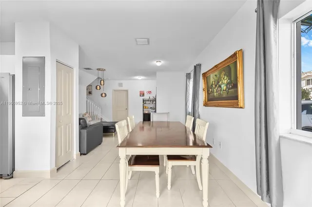 a dining room with furniture and window