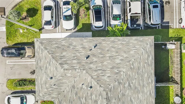a front view of a house with swimming pool and furniture