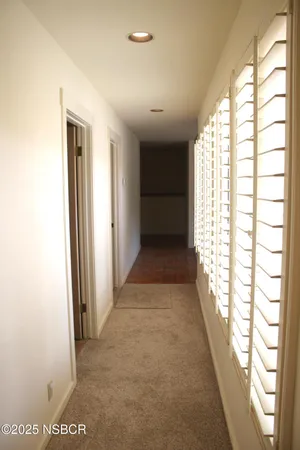 a view of hallway with windows
