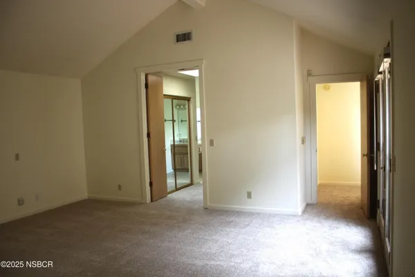 an empty room that has a glass door and painted walls