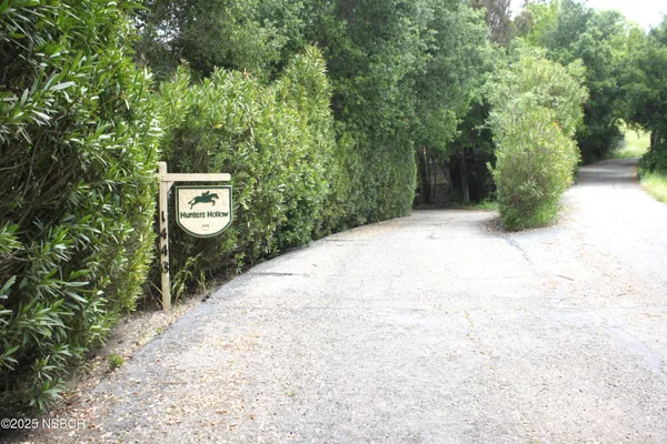 a view of a street with trees on both side of it