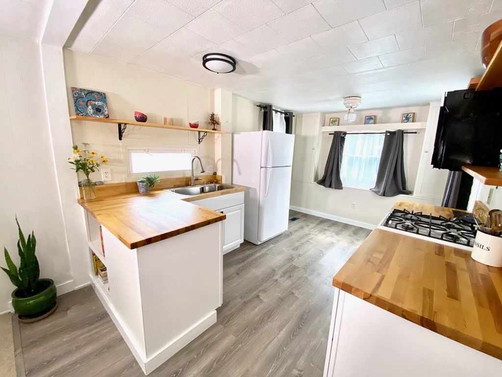 42 Adams Road, Unit 25 Greenfield, MA 01301 - Photo 12 of 37 a kitchen with stainless steel appliances granite countertop a stove and a refrigerator