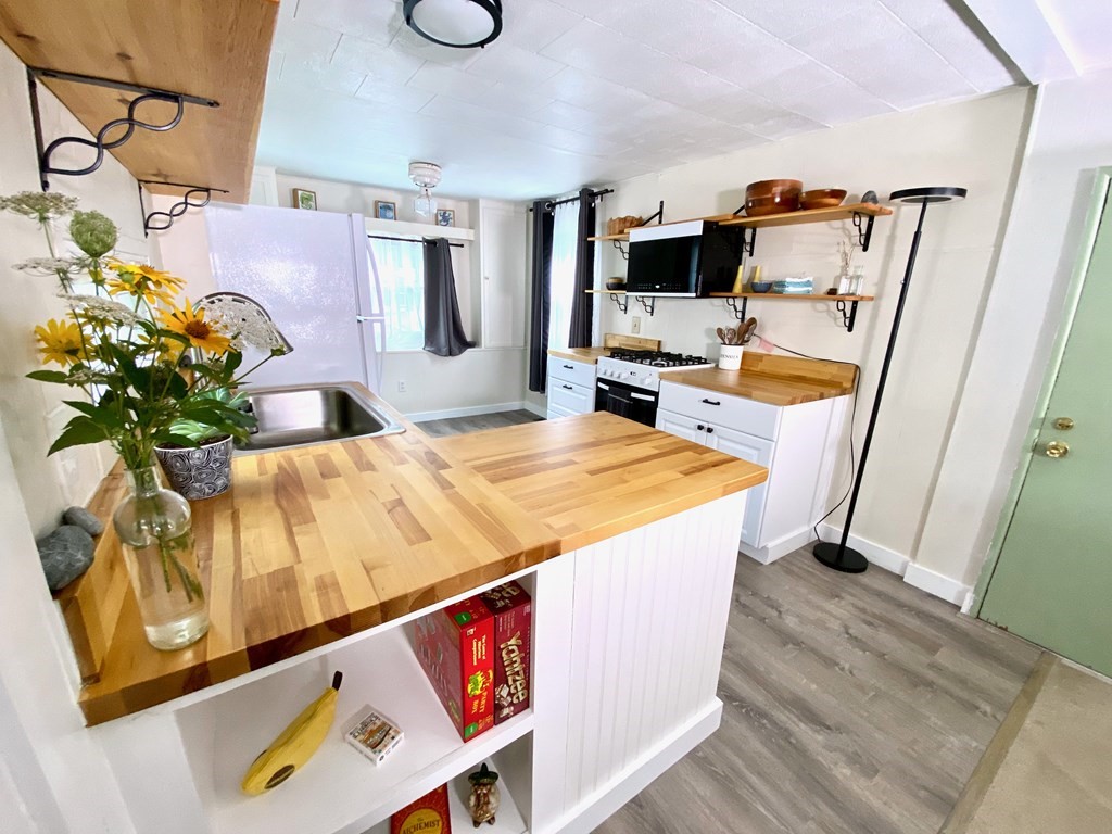 42 Adams Road, Unit 25 Greenfield, MA 01301 - Photo 13 of 37 a living room with stainless steel appliances kitchen island granite countertop furniture and a flat screen tv
