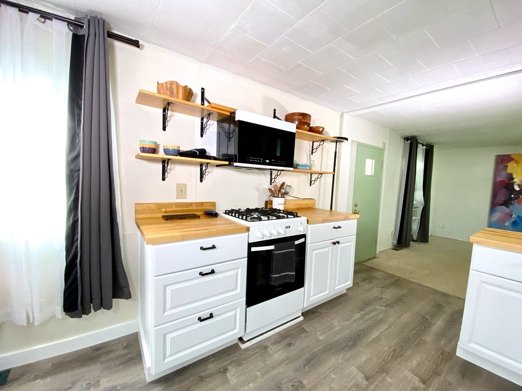 42 Adams Road, Unit 25 Greenfield, MA 01301 - Photo 17 of 37 a kitchen with stainless steel appliances a stove and a refrigerator
