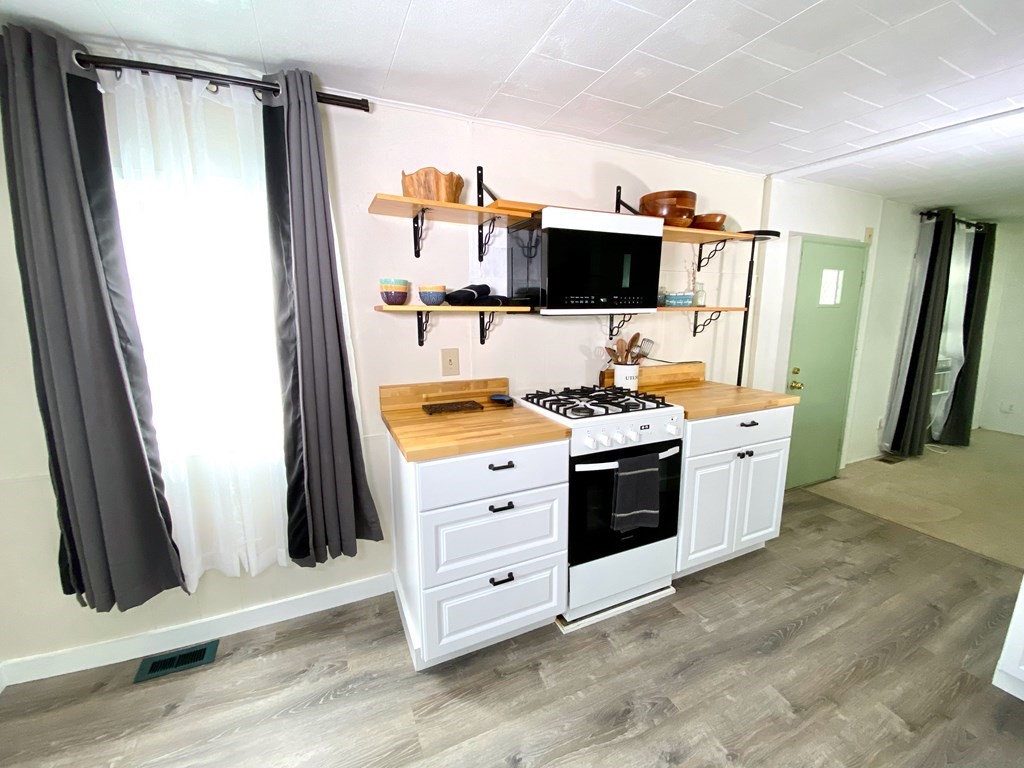 42 Adams Road, Unit 25 Greenfield, MA 01301 - Photo 18 of 37 a view of flat screen tv and refrigerator