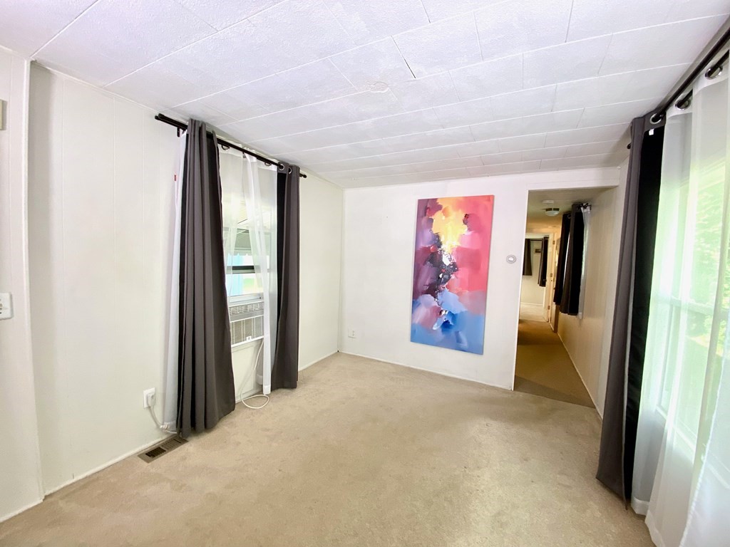 42 Adams Road, Unit 25 Greenfield, MA 01301 - Photo 20 of 37 an empty room with painting on the wall