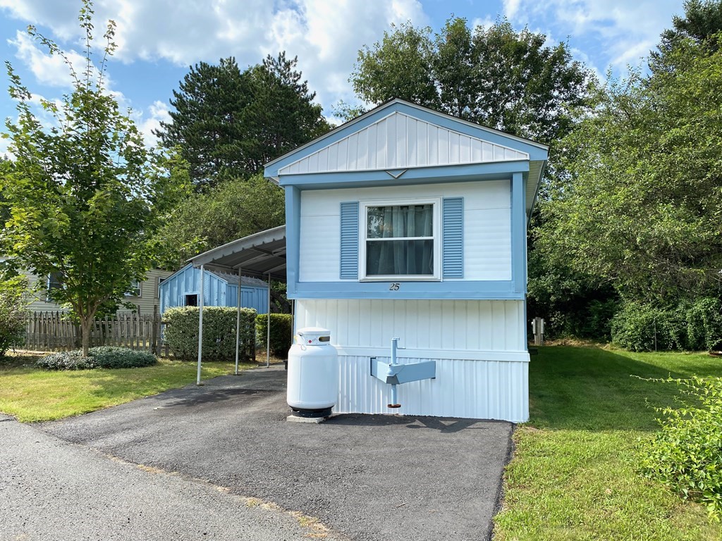 42 Adams Road, Unit 25 Greenfield, MA 01301 - Photo 3 of 37 a view of a house with a yard plants and large tree