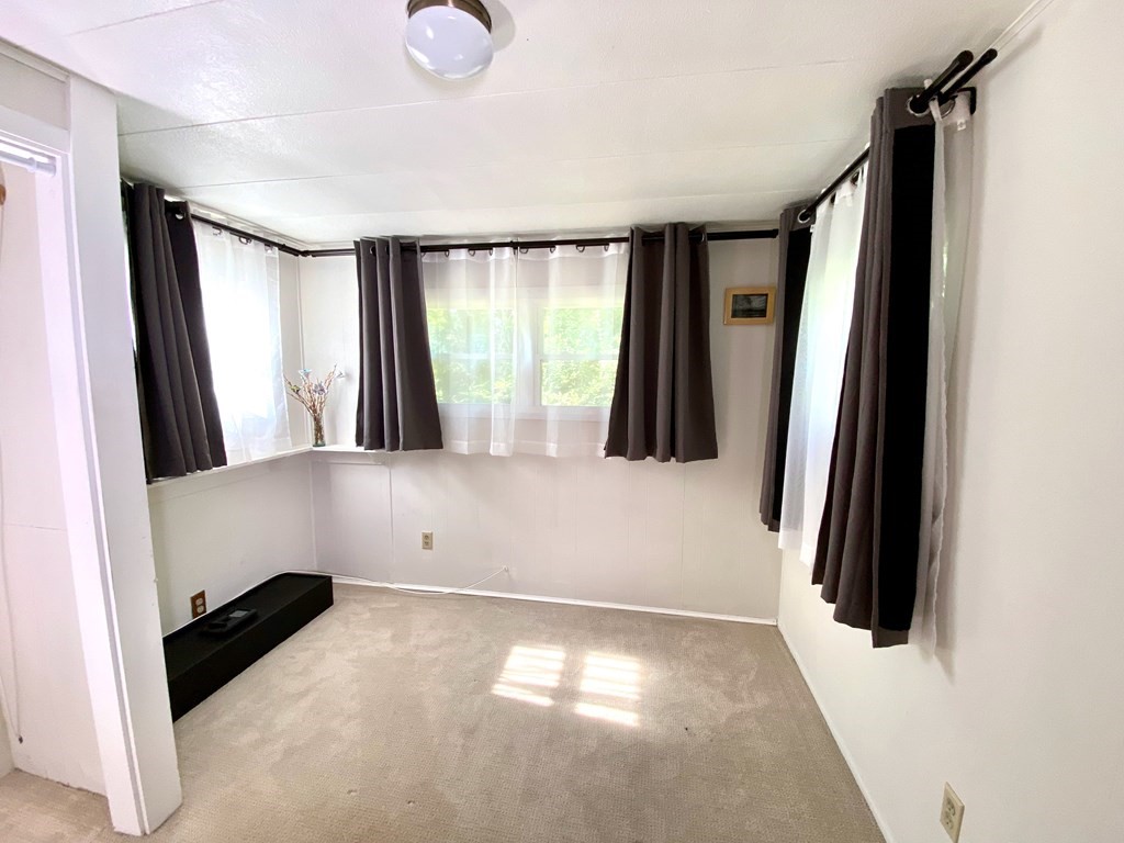 42 Adams Road, Unit 25 Greenfield, MA 01301 - Photo 31 of 37 a view of walk in closet with clothes and shoes