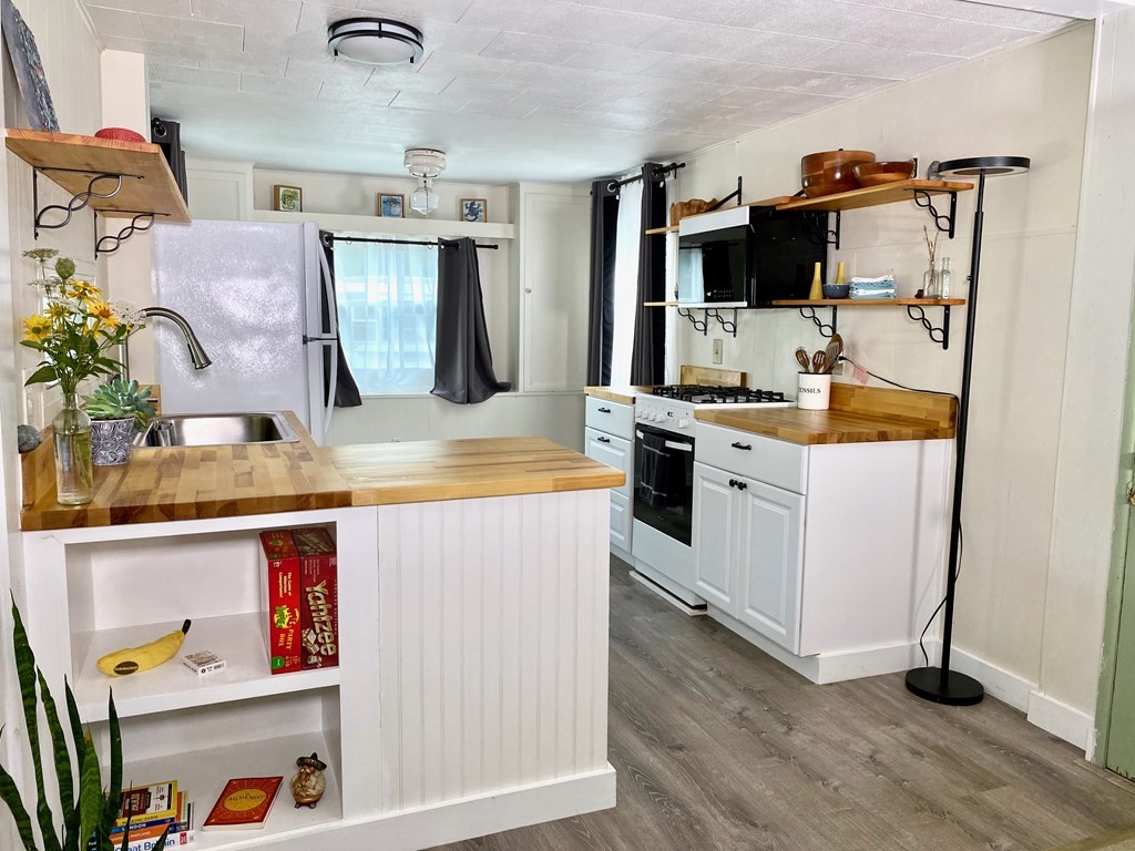 42 Adams Road, Unit 25 Greenfield, MA 01301 - Photo 8 of 37 a living room with stainless steel appliances furniture and a flat screen tv