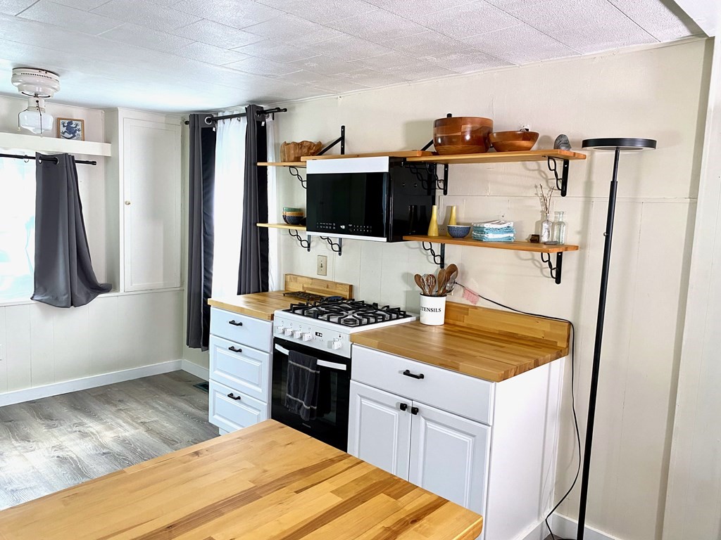 42 Adams Road, Unit 25 Greenfield, MA 01301 - Photo 9 of 37 a kitchen with stainless steel appliances granite countertop a refrigerator a stove and a sink