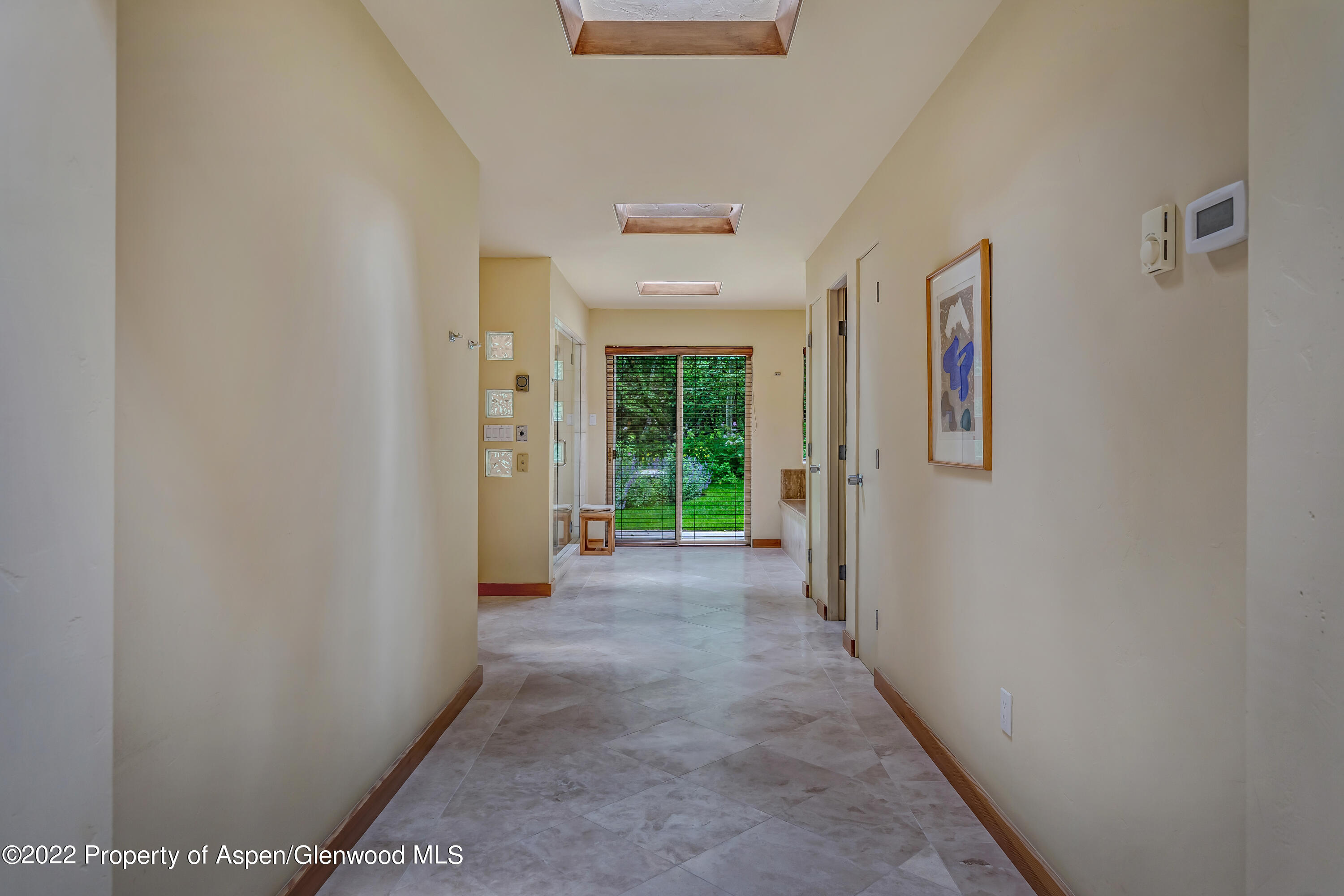 332 Glen Eagle Drive Aspen, CO 81611 - Photo 18 of 37 a view of a hallway with wooden shelves and windows