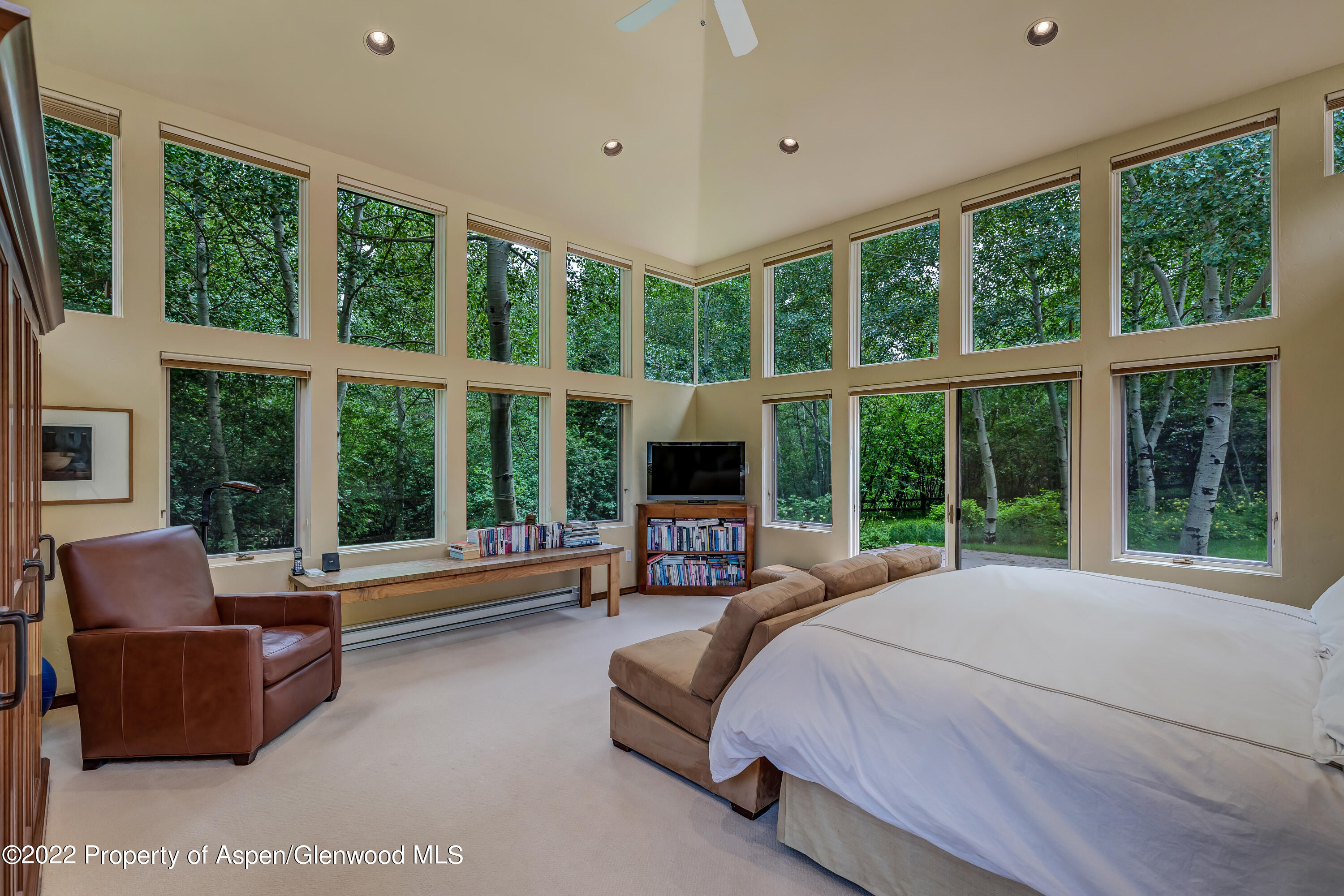 332 Glen Eagle Drive Aspen, CO 81611 - Photo 19 of 37 a spacious bedroom with a large bed and a large window