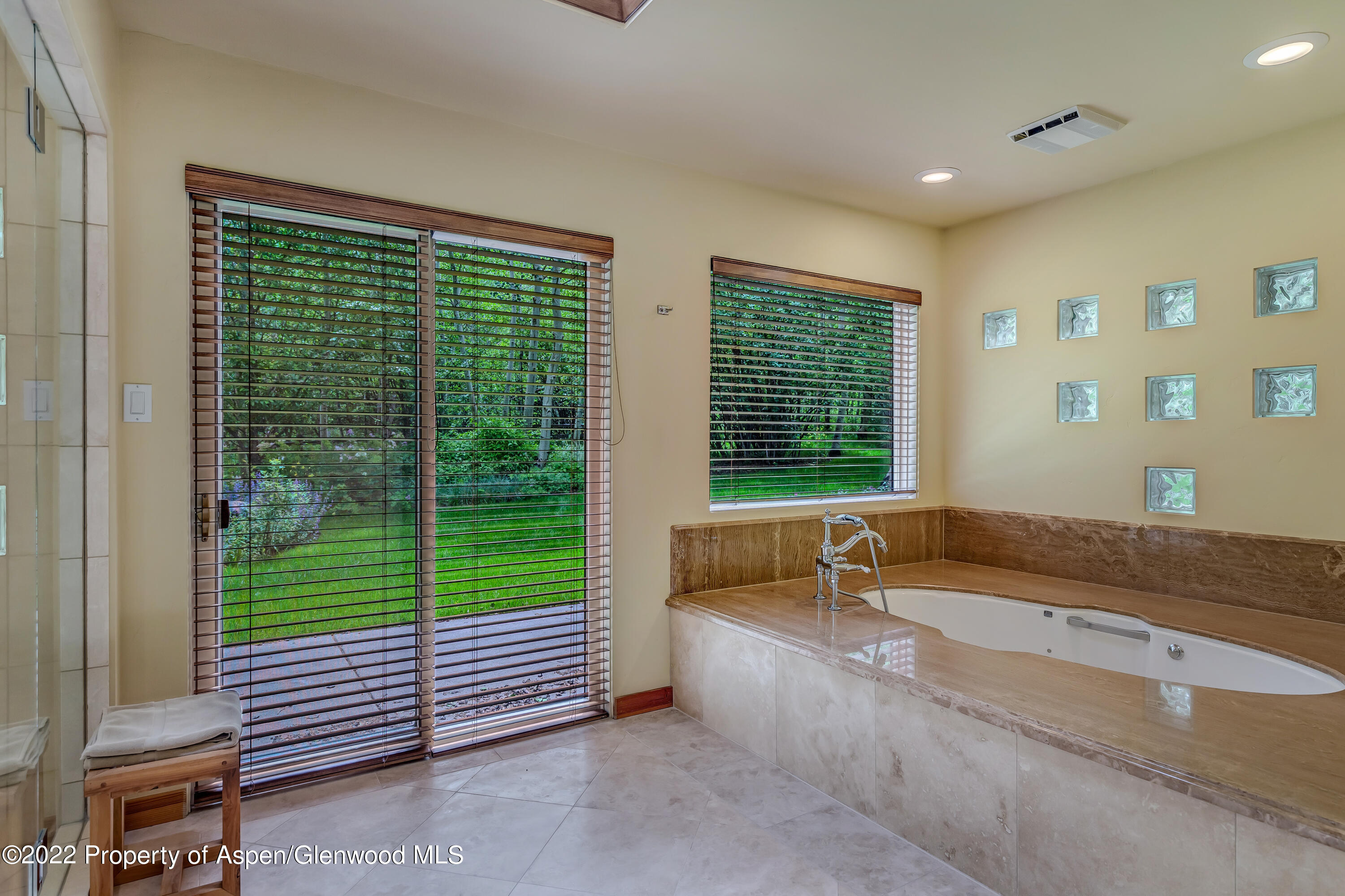 332 Glen Eagle Drive Aspen, CO 81611 - Photo 21 of 37 a bathroom with a bathtub and window