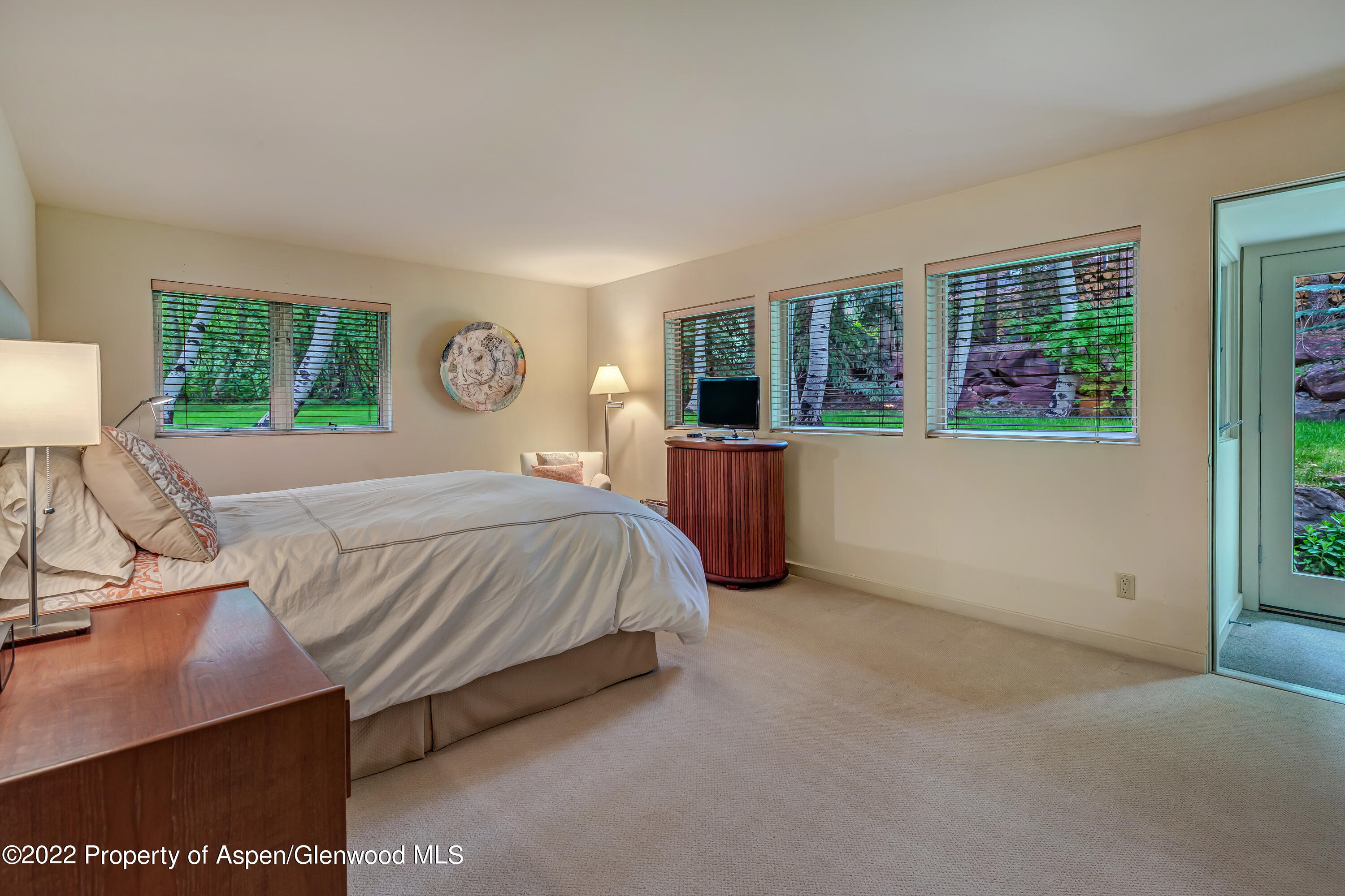 332 Glen Eagle Drive Aspen, CO 81611 - Photo 24 of 37 a bedroom with a large bed and a window