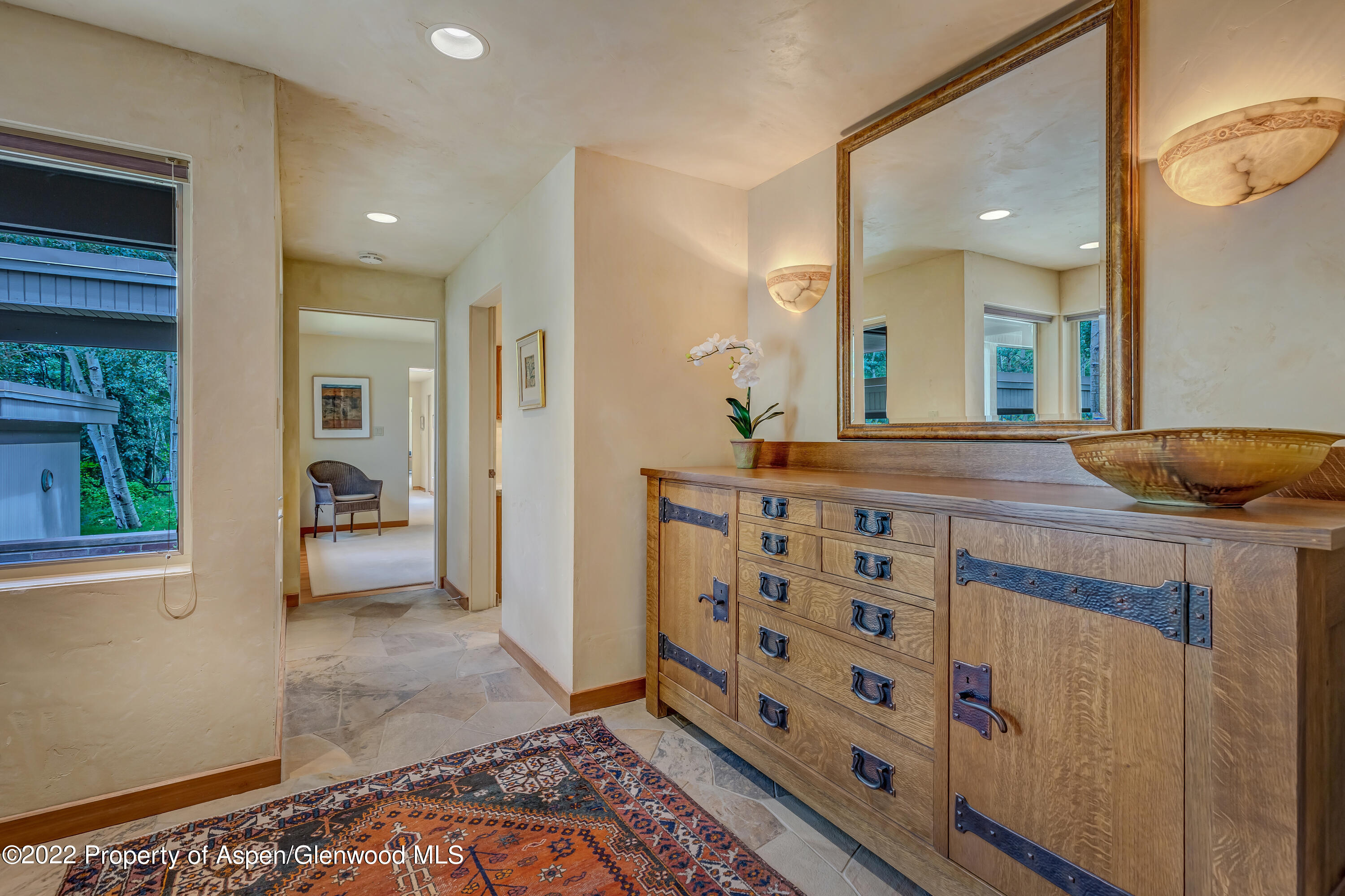 332 Glen Eagle Drive Aspen, CO 81611 - Photo 3 of 37 a bathroom with a sink a mirror and a shower