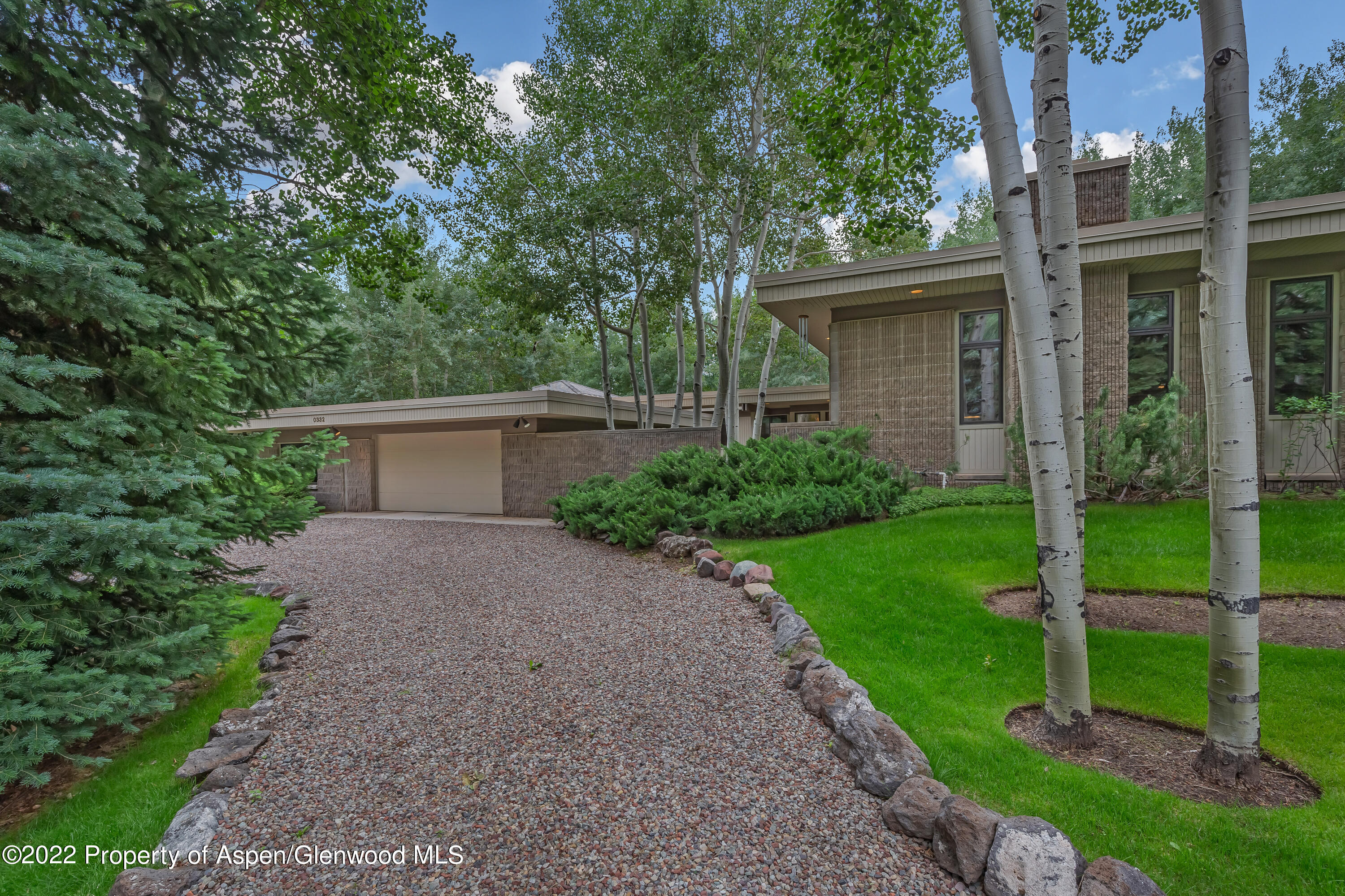 332 Glen Eagle Drive Aspen, CO 81611 - Photo 32 of 37 a front view of house with yard and green space