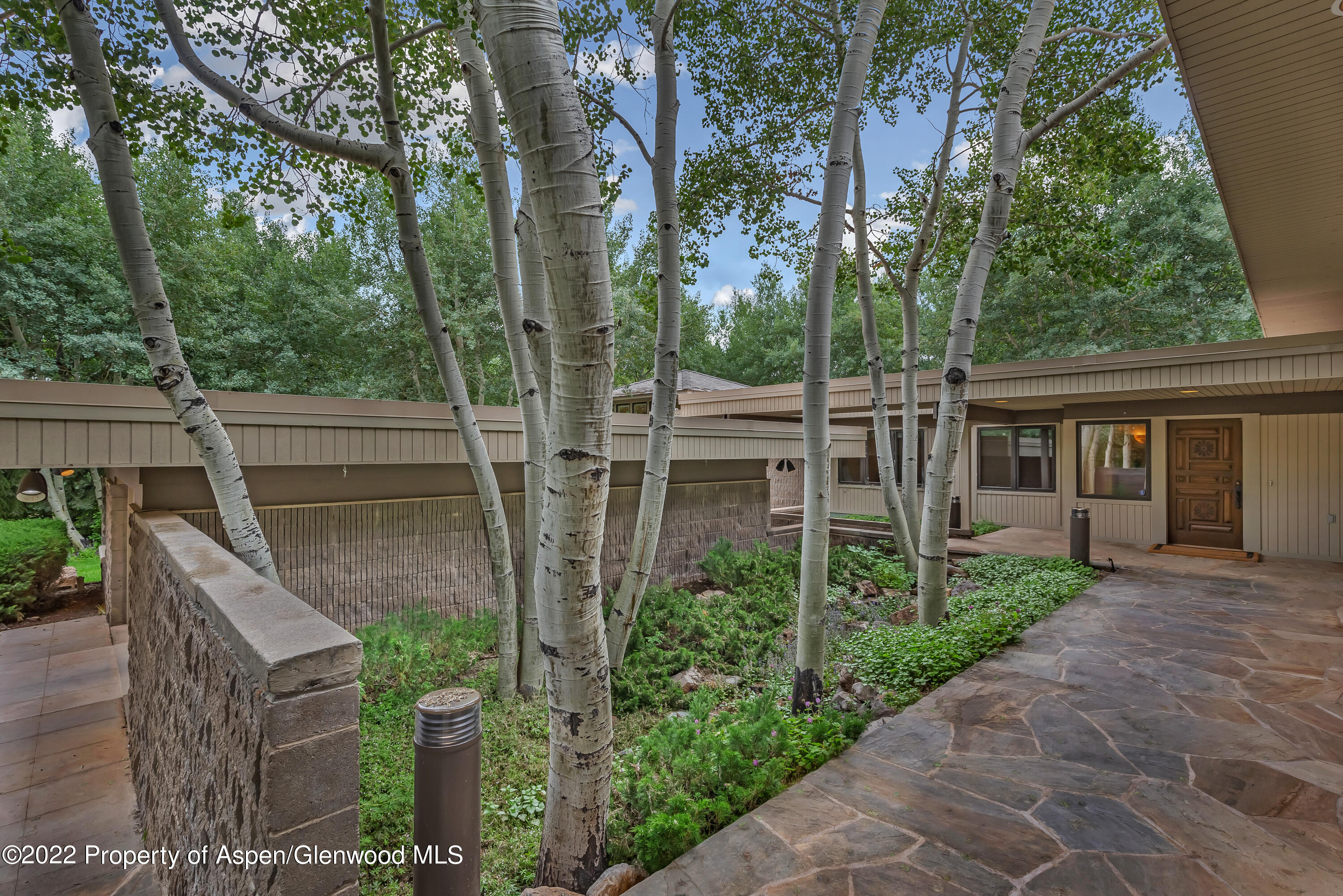 332 Glen Eagle Drive Aspen, CO 81611 - Photo 34 of 37 a view of house with outdoor seating and green space