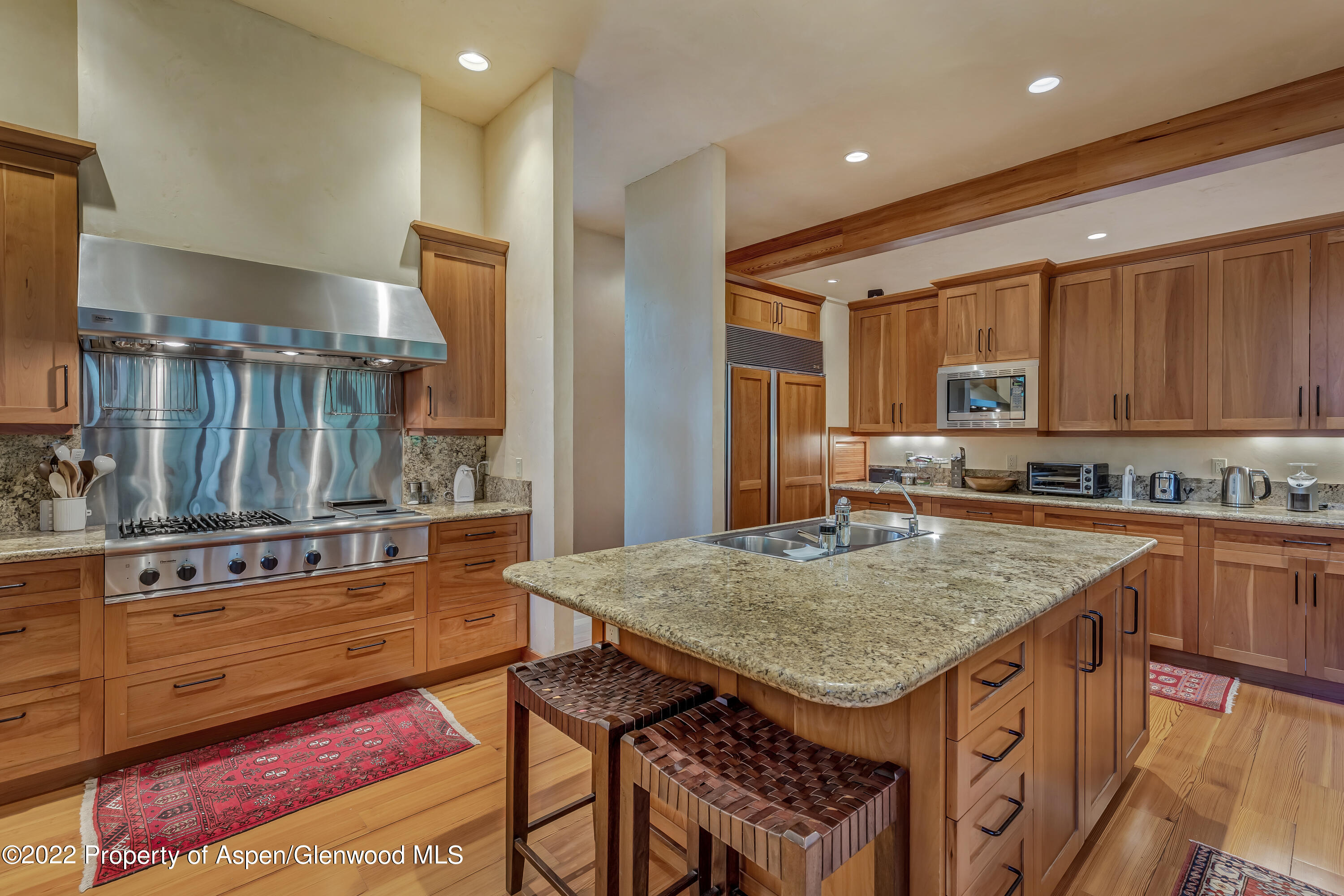 332 Glen Eagle Drive Aspen, CO 81611 - Photo 8 of 37 a kitchen with stainless steel appliances granite countertop a stove a sink dishwasher and cabinets with wooden floor