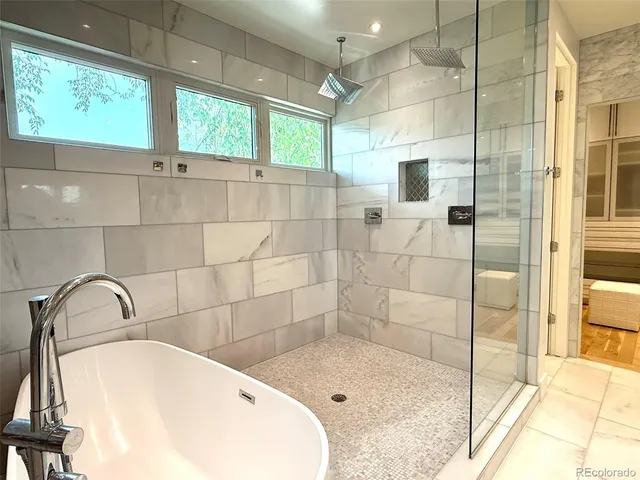 a bathroom with a bathtub and shower