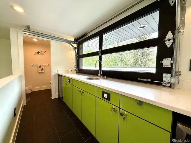 a kitchen with stainless steel appliances a sink and a large window