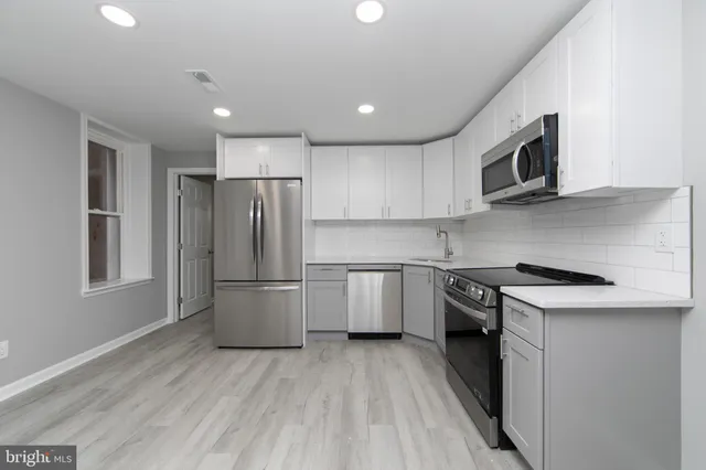 a kitchen with a stove a sink and a microwave