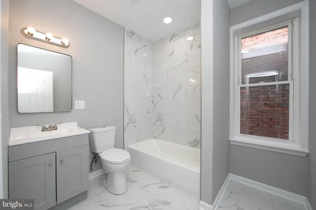 a bathroom with a toilet sink and bathtub