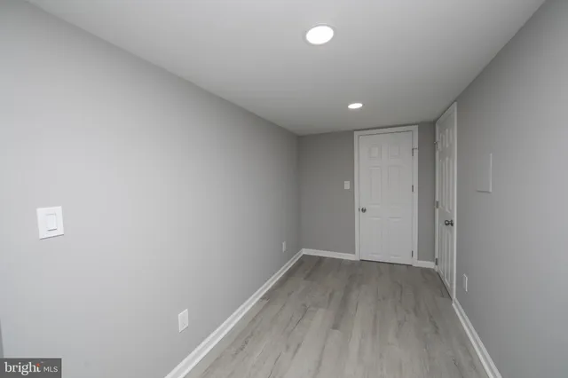 a view of a room with wooden floor and window