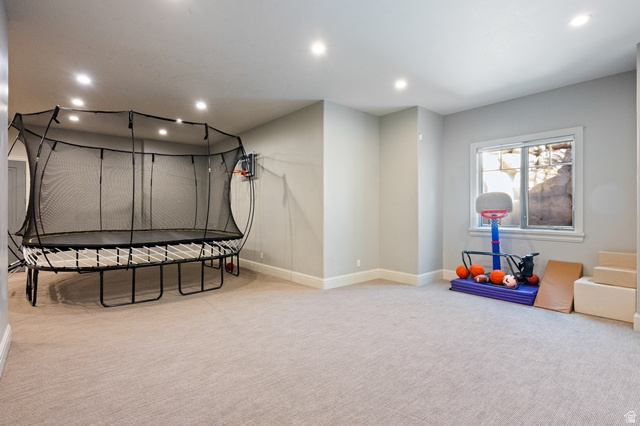 3 Carriagewood Cove, Unit 1088 Sandy, UT 84092 - Photo 62 of 79 Spacious recreation room featuring recessed lighting, light gray wall paint, and neutral carpeting