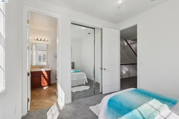 a bedroom with a bed and a view of bathroom