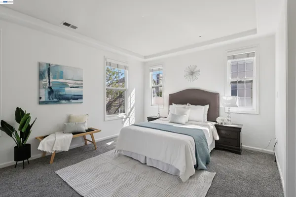 a bedroom with a large bed and a window