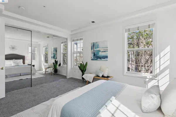 a bedroom with a bed and a large window