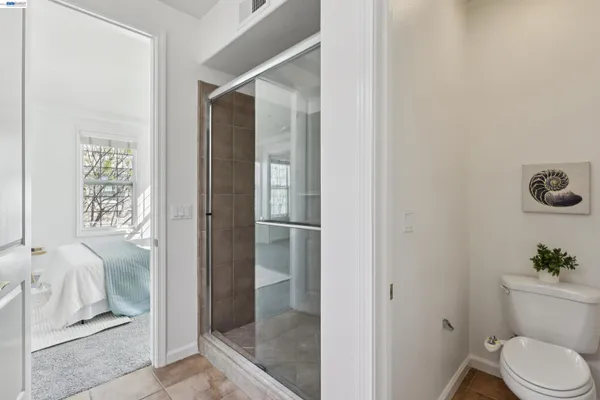 a bathroom with a toilet and a shower