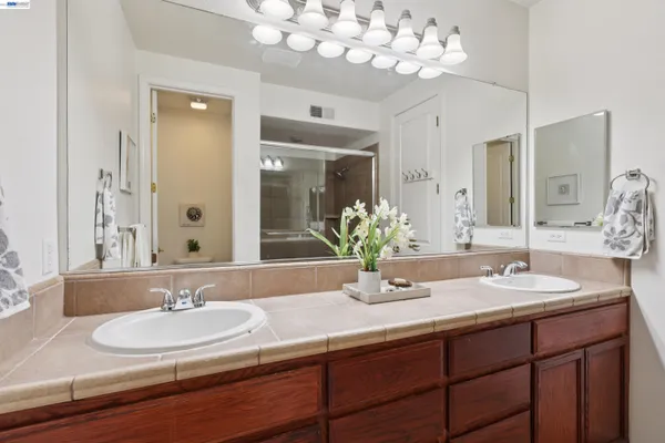 a bathroom with a sink double vanity and a mirror