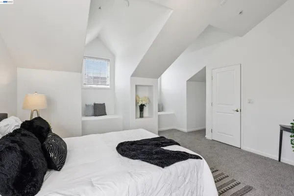 a bedroom with a bed and a lamp